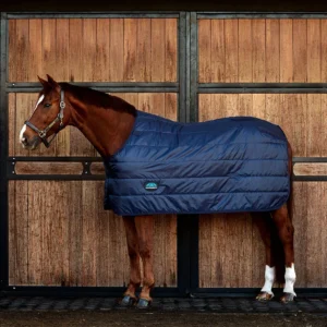 Equip your horse with the WeatherBeeta ComFiTec Thermi-Heat Liner for ultimate warmth and comfort. This innovative liner features Thermi-Heat technology to keep your horse snug during chilly mornings. 100g polyfill delivers the ideal amount of insulation – without the bulk. Enhanced warmth and comfort: Strong 210T with Thermi-Heat lining and 100g polyfill offers superior warmth, keeping your horse cosy. Heat loss prevention: Thermi-heat lining uses thermal reflection to maintain warmth. Easy fit: Single touch tape front closure delivers a swift, secure fit. Secure attachment: Neck touch tape tabs attach to outer rug to keep the liner in place. Versatile layering: Rear clips allow for optional layering. Customisable stability: Integrated leg loops offer the option to add leg straps, enhancing the rug's stability.